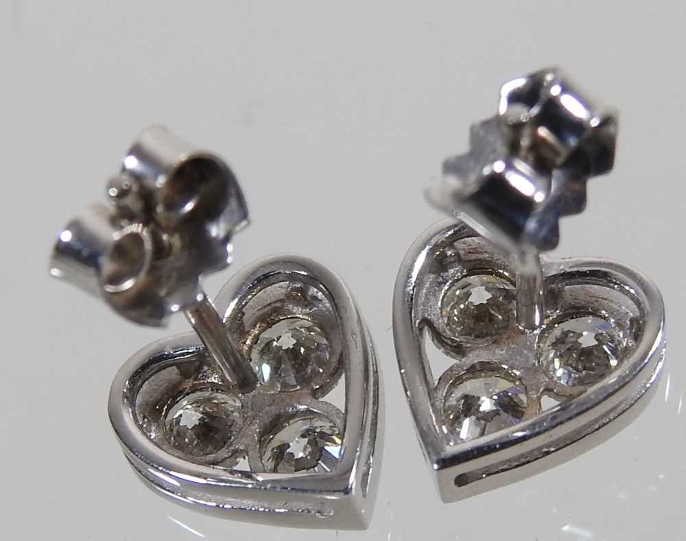 A pair of 18 carat white gold and diamond heart shaped earrings, each set with three, 1.9g, - Image 2 of 4
