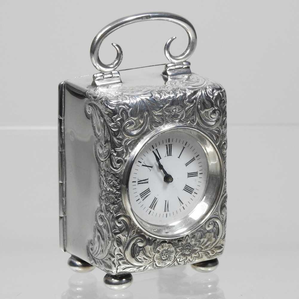 A Victorian silver cased boudoir clock, having a white enamel dial and French movement, Birmingham
