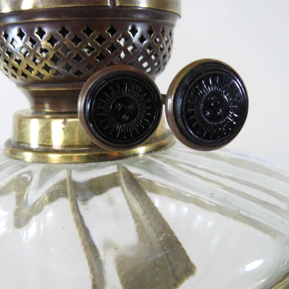 An ornate 19th century brass oil lamp, with an etched glass shade, clear glass font and scrolled - Image 2 of 6
