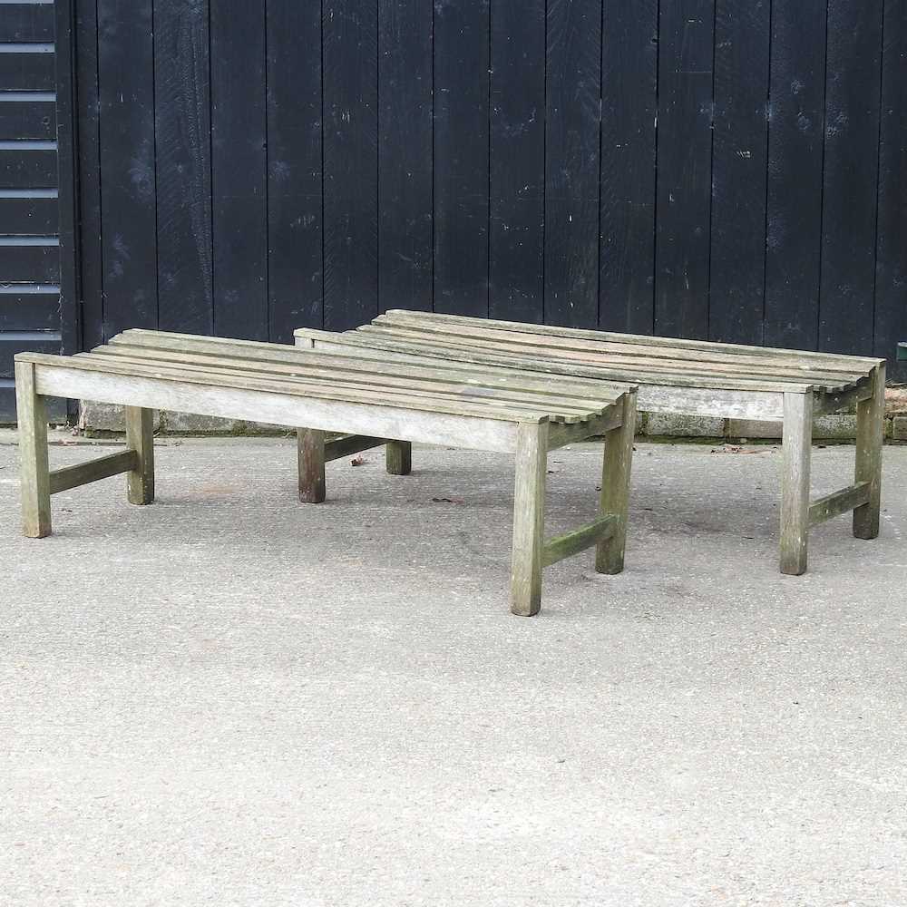 A pair of slatted hardwood garden benches (2) 140w x 48d x 44h cm