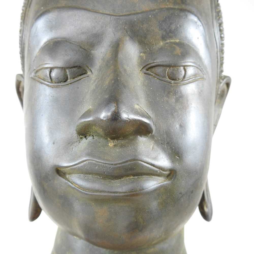 An Eastern bronze life-sized Buddha head, probably 20th century, mounted on a wooden base, 73cm high - Image 5 of 11