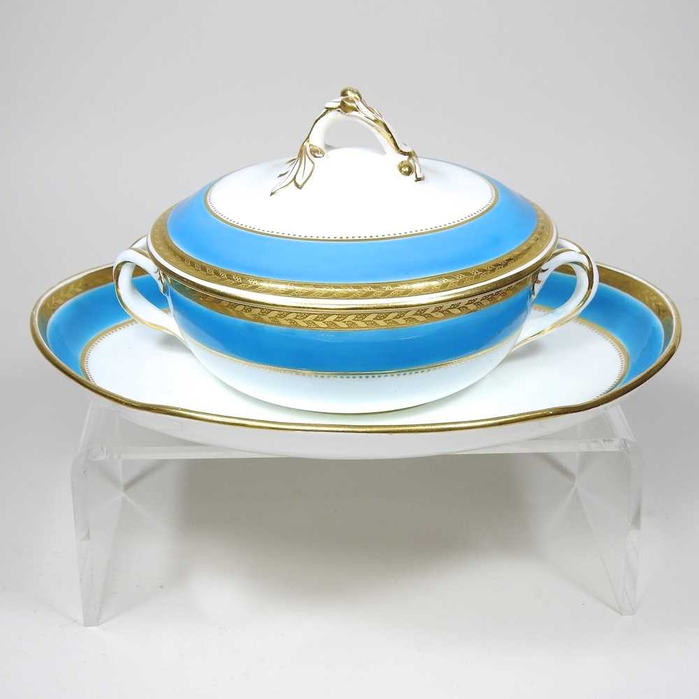 A 19th century Minton tureen and cover on stand, with a blue and gilt border, impressed marks to