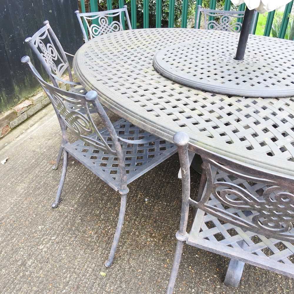 A large cast metal oval garden table, together with a set of eight garden chairs and a parasol base, - Image 2 of 5