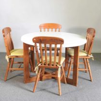 A 1970's Formwood Ltd circular dining table, 109cm diameter, together with a set of four stained