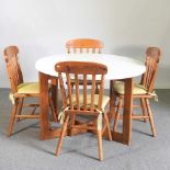 A 1970's Formwood Ltd circular dining table, 109cm diameter, together with a set of four stained
