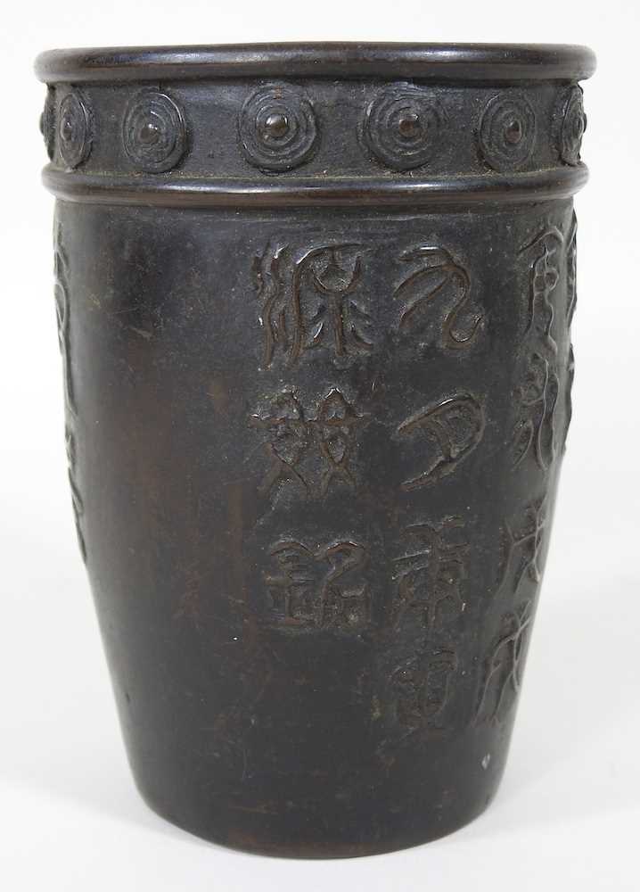 A Chinese bronze beaker, decorated in relief with symbols, signed to base, 13cm high - Image 3 of 7