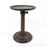 A 19th century turned mahogany stand, with an adjustable dished top, on a weighted base, 15cm
