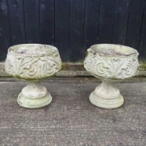 A pair of cast stone garden pots, on pedestal bases, 48cm high (2()