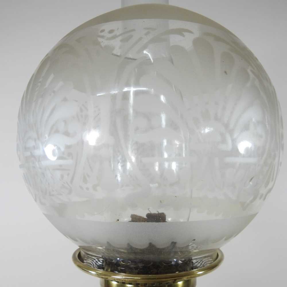 An ornate 19th century brass oil lamp, with an etched glass shade, clear glass font and scrolled - Image 5 of 6