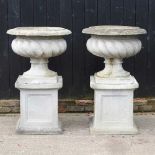 A pair of large simulated stone garden planters, each of fluted design, on a pedestal base (2) 72d x