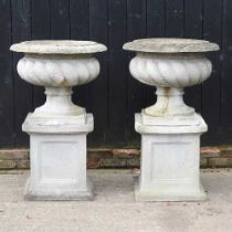 A pair of large simulated stone garden planters, each of fluted design, on a pedestal base (2) 72d x