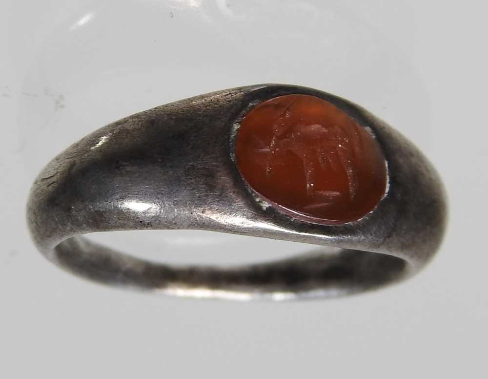 A Roman silver intaglio signet ring, circa 100-300AD, the oval carnelian engraved with a stag, - Image 4 of 5