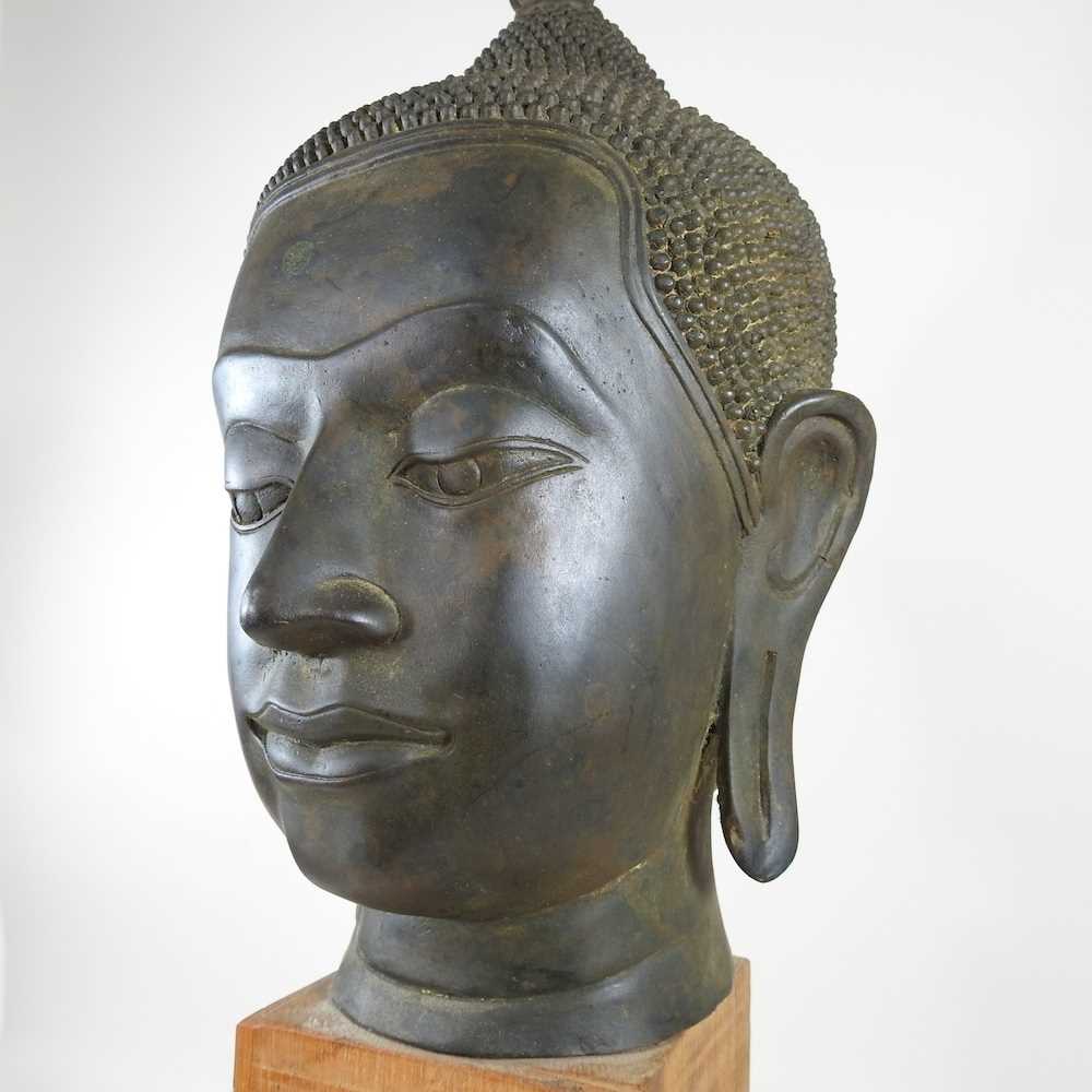 An Eastern bronze life-sized Buddha head, probably 20th century, mounted on a wooden base, 73cm high - Image 4 of 11