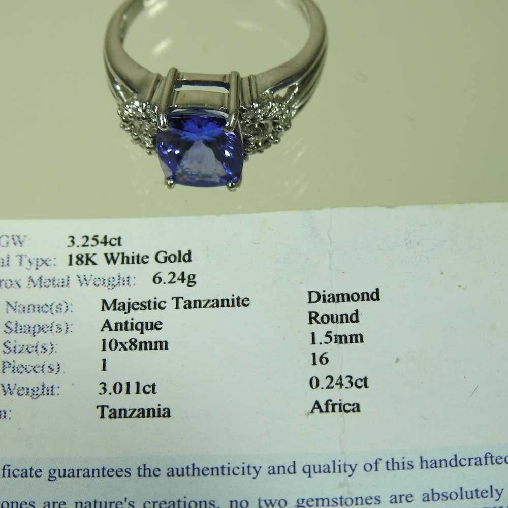 An 18 carat white gold, diamond and tanzanite dress ring, the central stone approximately three - Image 6 of 6