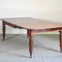 A Victorian style pull out extending dining table, 20th century, with four additional leaves, on