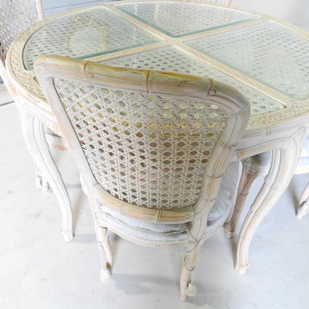 A carved wood and limed dining table, with a glass top, 107cm diameter, together with a set of - Image 2 of 4