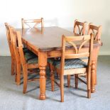 A modern pine dining table, on turned legs, together with a set of six pine dining chairs (7) 183w x