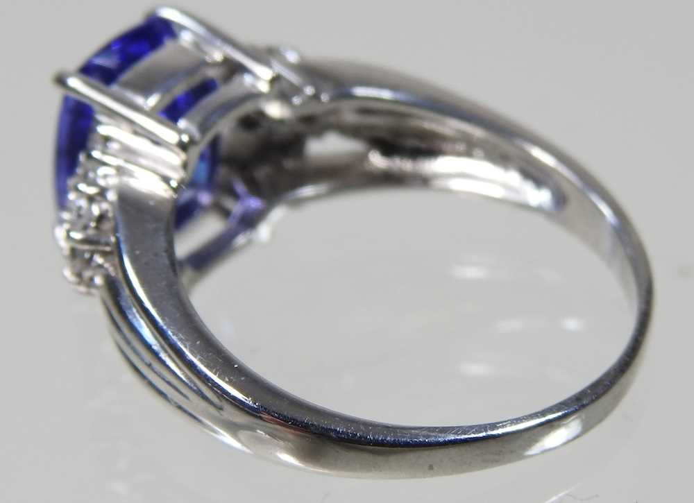 An 18 carat white gold, diamond and tanzanite dress ring, the central stone approximately three - Image 5 of 6