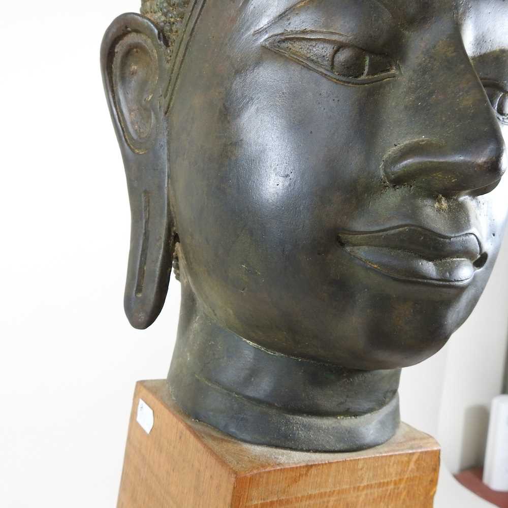 An Eastern bronze life-sized Buddha head, probably 20th century, mounted on a wooden base, 73cm high - Image 6 of 11