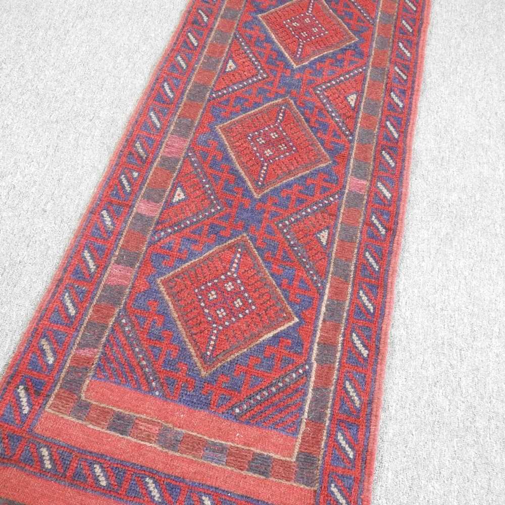 A Persian runner, with five central medallions, on a red ground, 236 x 55cm - Image 3 of 5