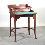 An early 20th century mahogany military style writing desk, with a dual hinged top, revealing a