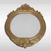 A 19th century carved pine and gilt gesso framed wall mirror, of oval shaped, with an acanthus