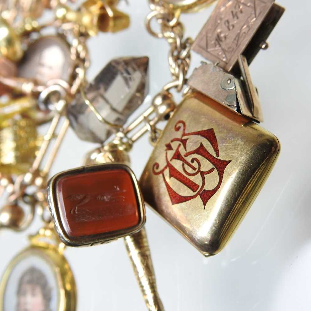 A gold charm bracelet, suspended with twenty-three various novelty charms, to include a sovereign - Image 11 of 12