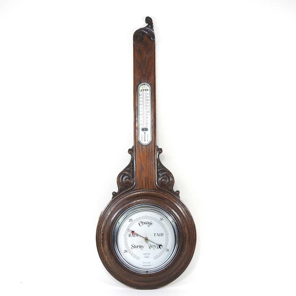 An early 20th century oak cased aneroid barometer, 89cm high