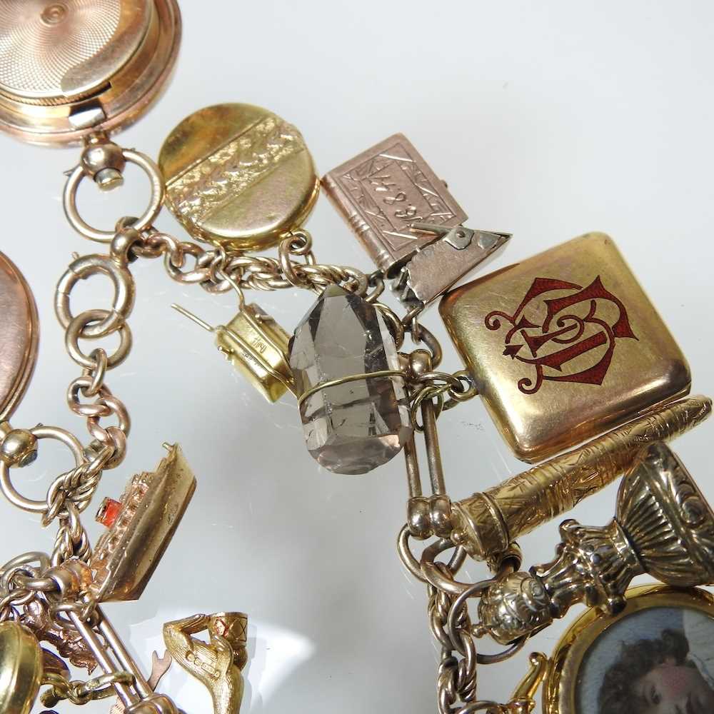 A gold charm bracelet, suspended with twenty-three various novelty charms, to include a sovereign - Image 6 of 12