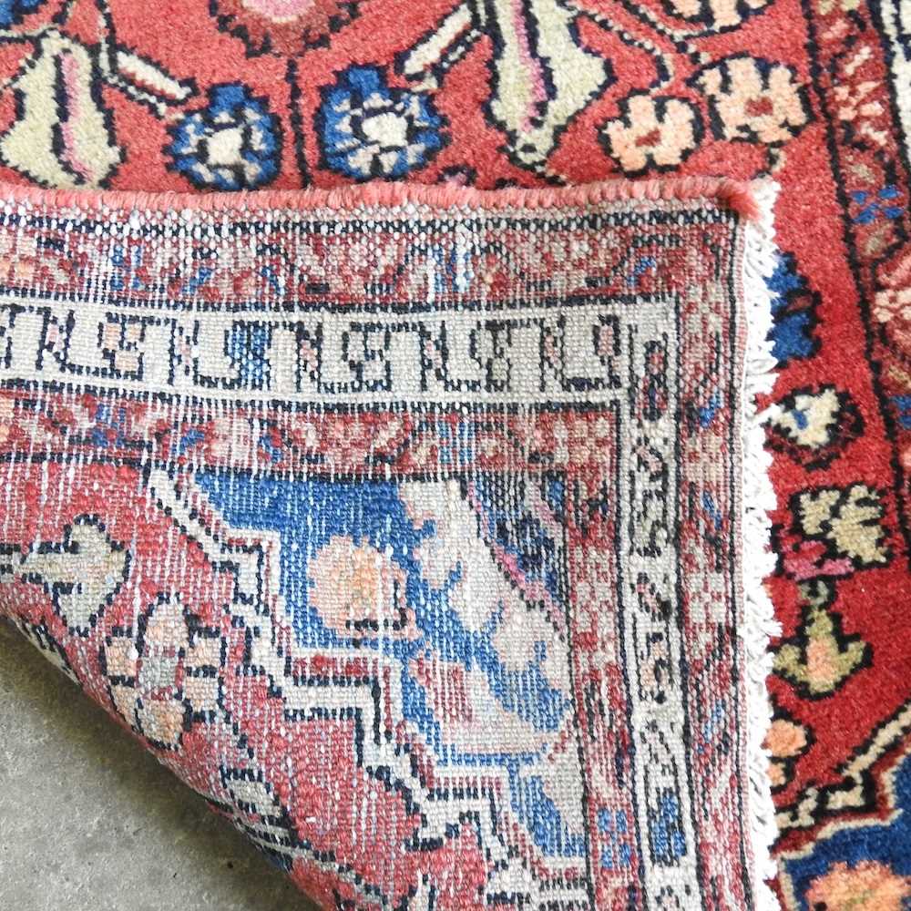A Persian Sarouk runner, with foliate designs, on a red ground, 330 x 80cm - Image 2 of 3