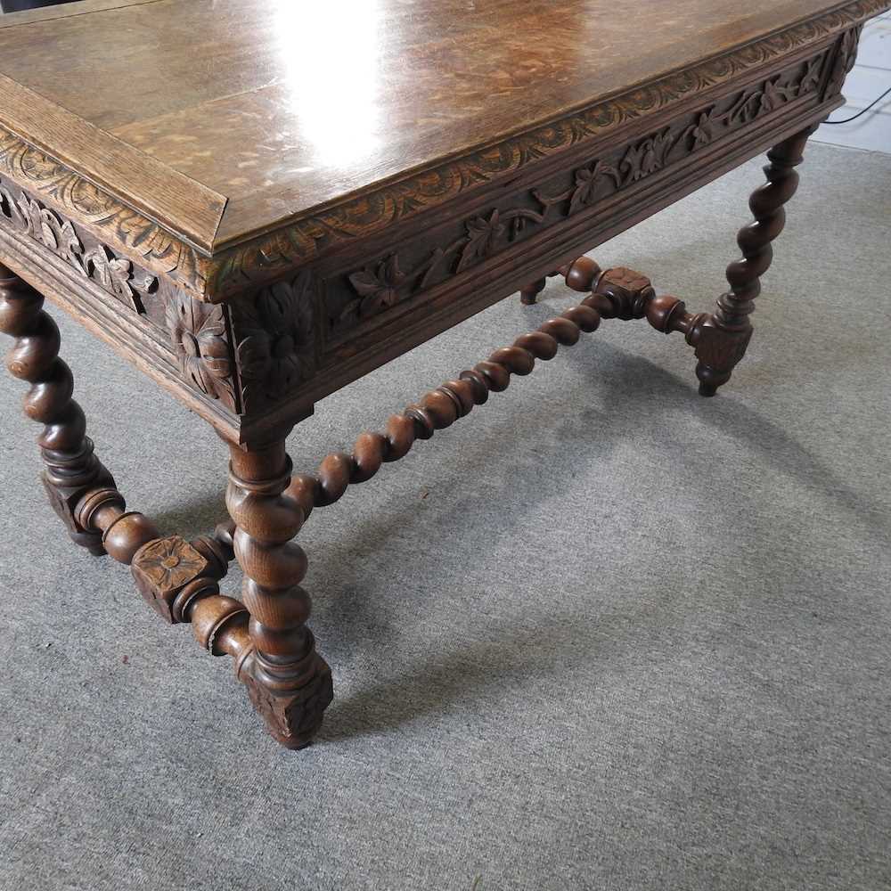 An early 20th century carved oak writing table, on spirally turned supports 120w x 60d x 75h cm - Image 5 of 5