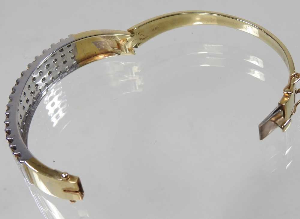 A 14 carat gold and diamond bangle, of hinged design, set with seventeen rows of four diamonds, - Image 2 of 6