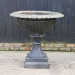 A large black painted cast iron garden planter, of fluted pedestal design 97d x 93h cm