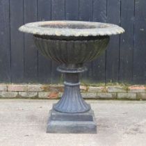 A large black painted cast iron garden planter, of fluted pedestal design 97d x 93h cm