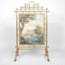 A 19th century simulated bamboo gilt fire screen, inset with a panel painted with a pastoral