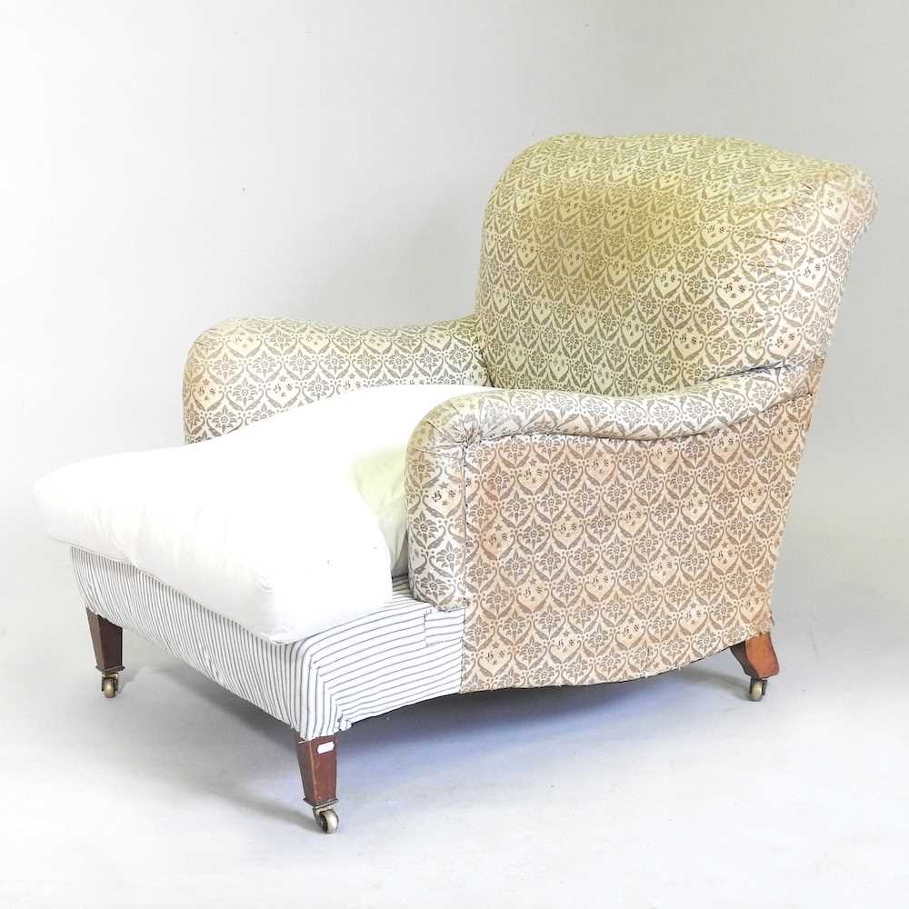 An early 20th century upholstered armchair, by Howard & Sons Ltd, with some original ticking bearing