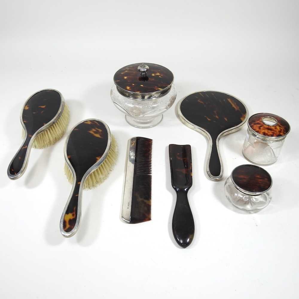 An early 20th century silver mounted tortoiseshell part dressing table set, to include a hair tidy