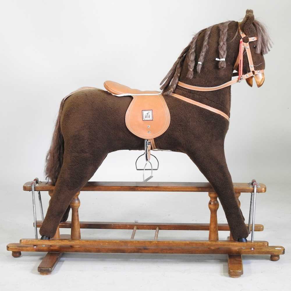 A Mamas and Papas fabric rocking horse, on a trestle base, 106cm high