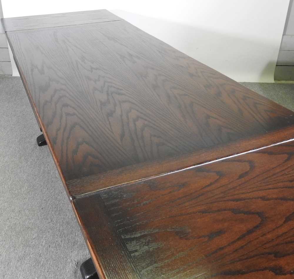 A mid 20th century oak draw leaf dining table, on cup and cover legs 275w x 92d x 76h cm - Image 5 of 5