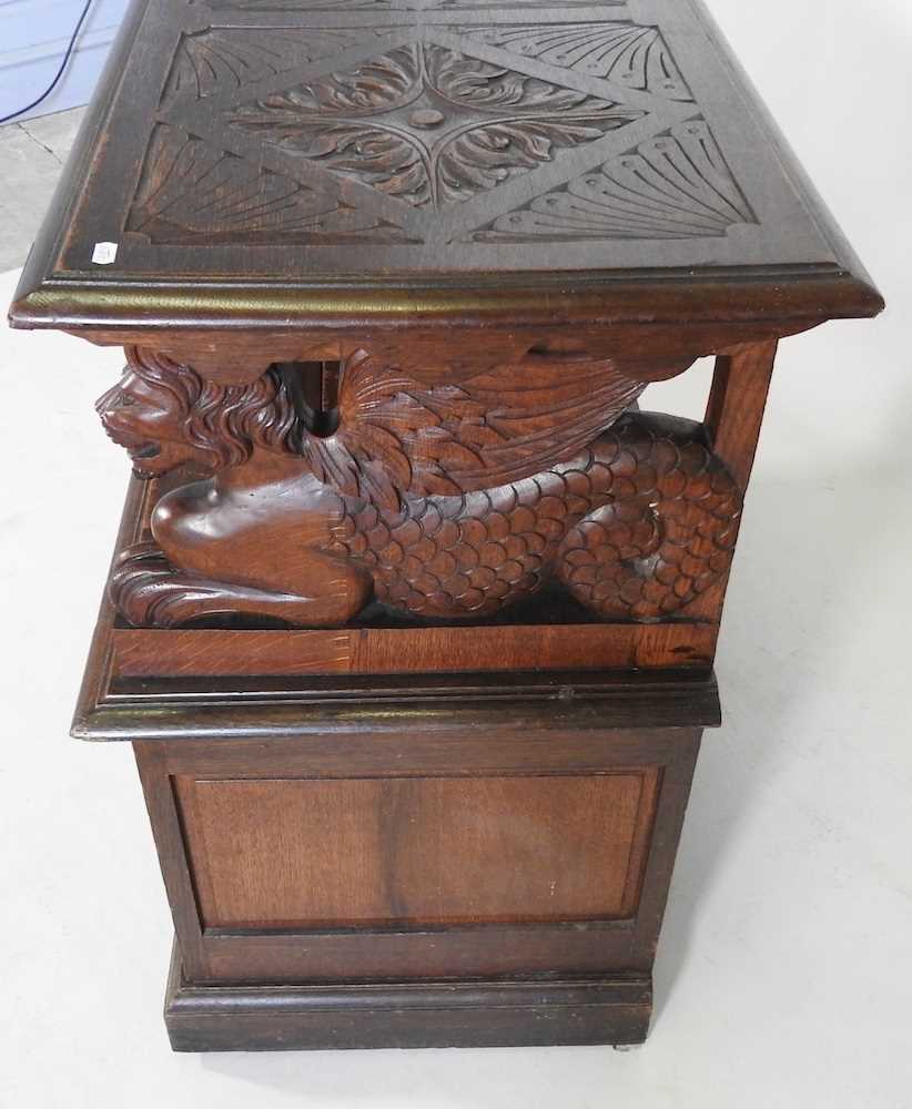 An early 20th century carved oak monk's bench, with griffin supports 92w x 50d x 82h cm - Image 9 of 10