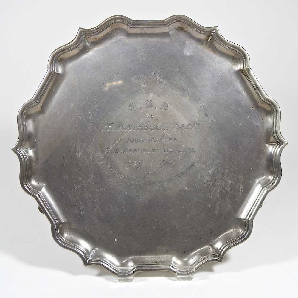 A mid 20th century silver salver, of circular shape, with a piecrust border, on hoof feet, with