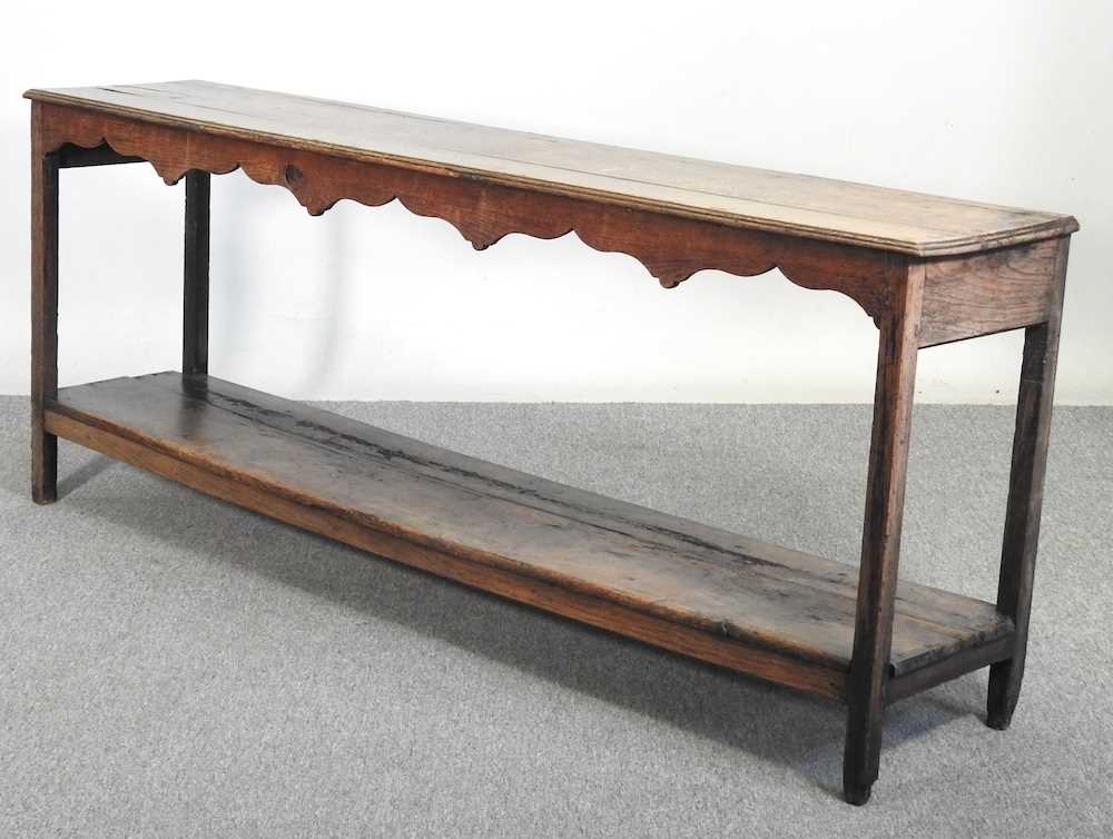 An 18th century Welsh dresser base, of narrow proportions, with an undulating frieze, on square - Image 11 of 19
