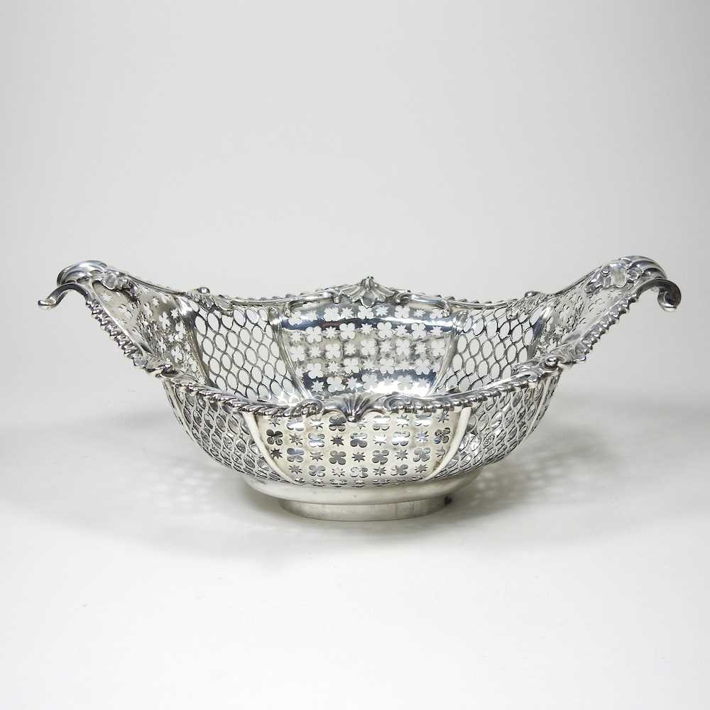 A good George III pierced silver sweetmeat basket, of pierced boat shape, the gadrooned border