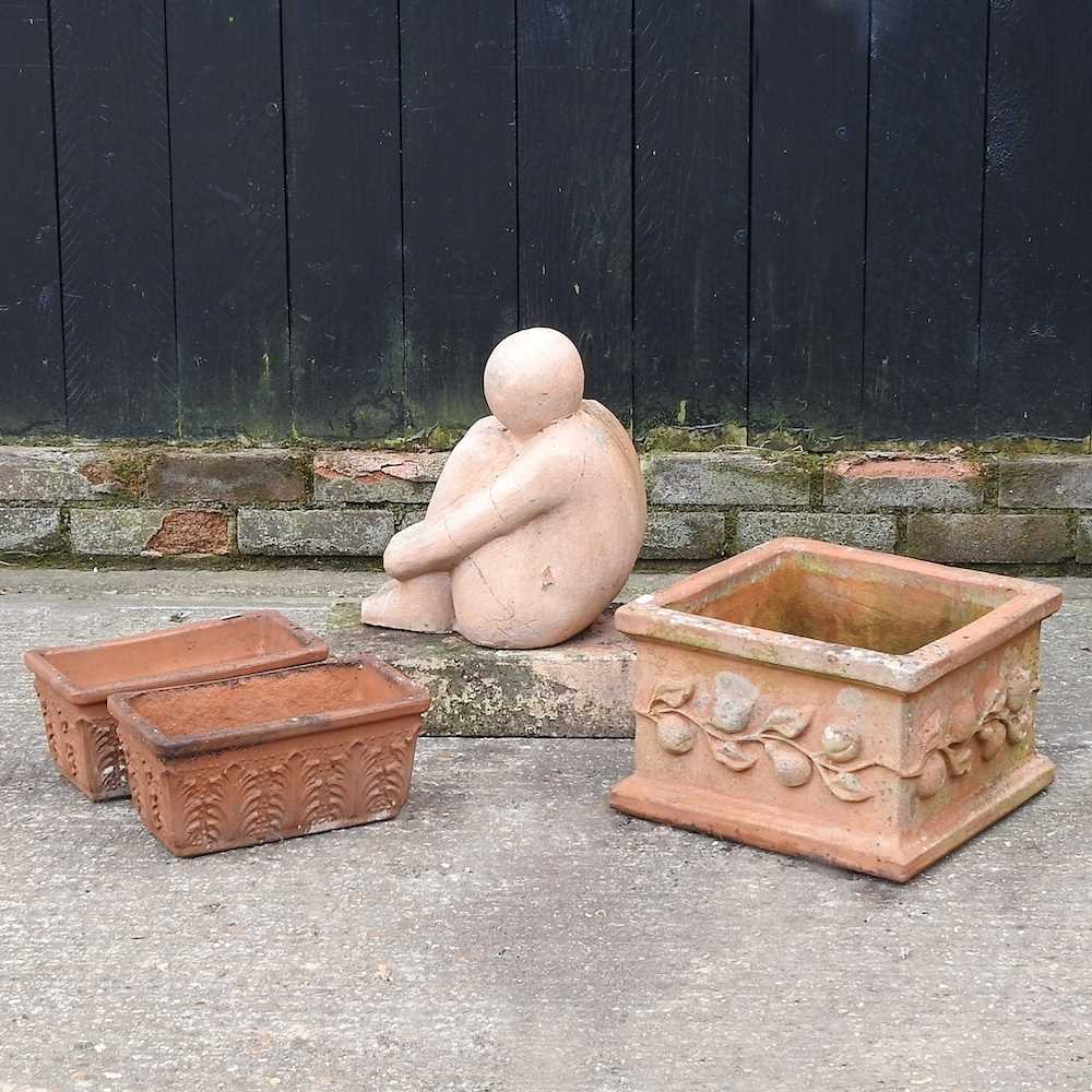 A terracotta garden pot, together with two smaller and a statue (4)
