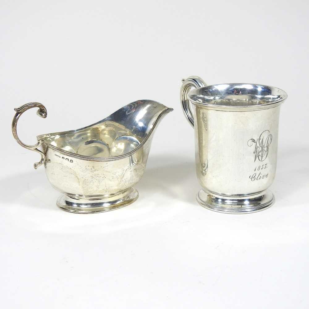 A Victorian silver mug, with a scrolled handle, London 1856, 97g, 9cm high, together with a silver