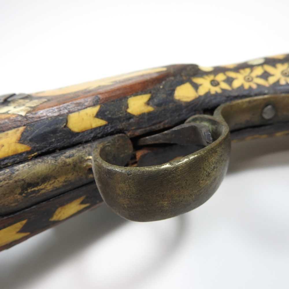 A middle Eastern flintlock pistol, with bone inlay, 40cm long Overall condition is complete. It is - Image 2 of 8