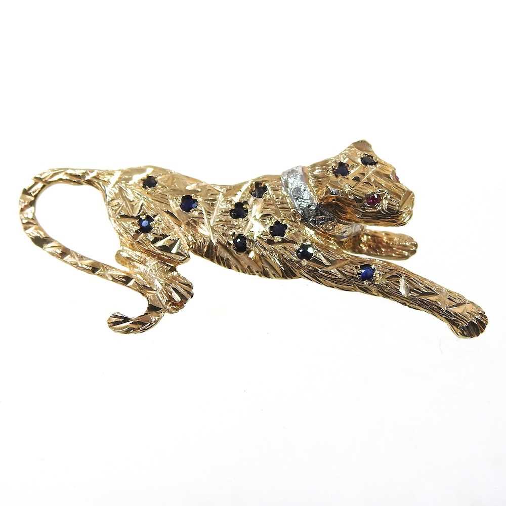 A 9 carat gold brooch, in the form of a panther, with sapphire spots, ruby eyes and a diamond