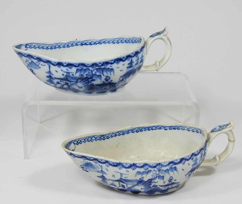 A pair of 18th century Staffordshire blue and white sauce boats, circa 1790, each painted with - Image 3 of 10