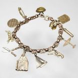 An early 20th century charm bracelet, suspended with a collection of twelve various novelty