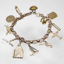 An early 20th century charm bracelet, suspended with a collection of twelve various novelty